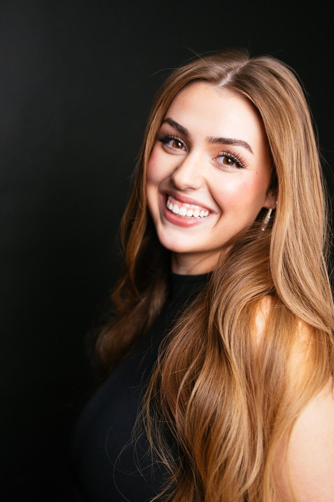 Bright studio headshot of Elena in wardrobe look 9