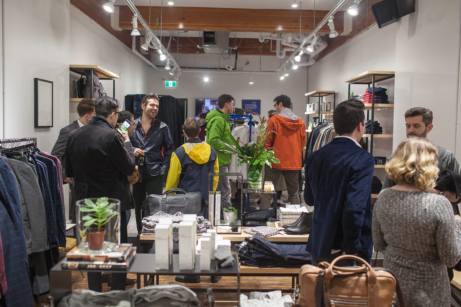 Frank & Oak Colour corporate story frame 29: Retail event photography for Frank & Oak Colour at The Blue Shop on Abbott Street in Vancouver, with the storefront, guests, clothing, details and the room in use.