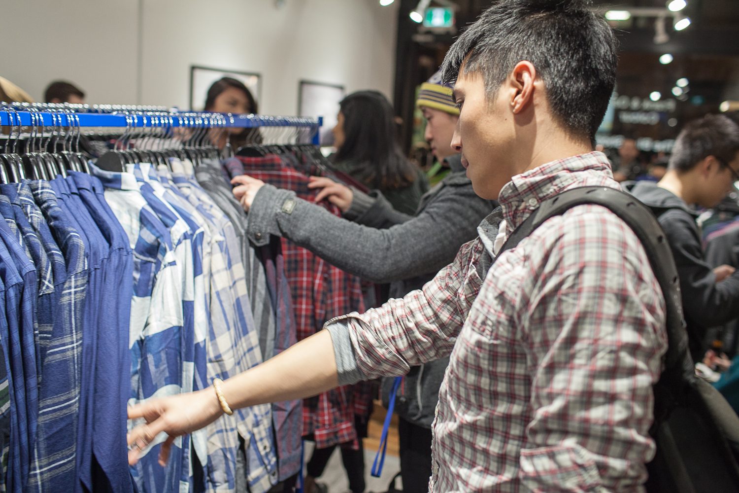 Frank & Oak Colour corporate story frame 17: Retail event photography for Frank & Oak Colour at The Blue Shop on Abbott Street in Vancouver, with the storefront, guests, clothing, details and the room in use.
