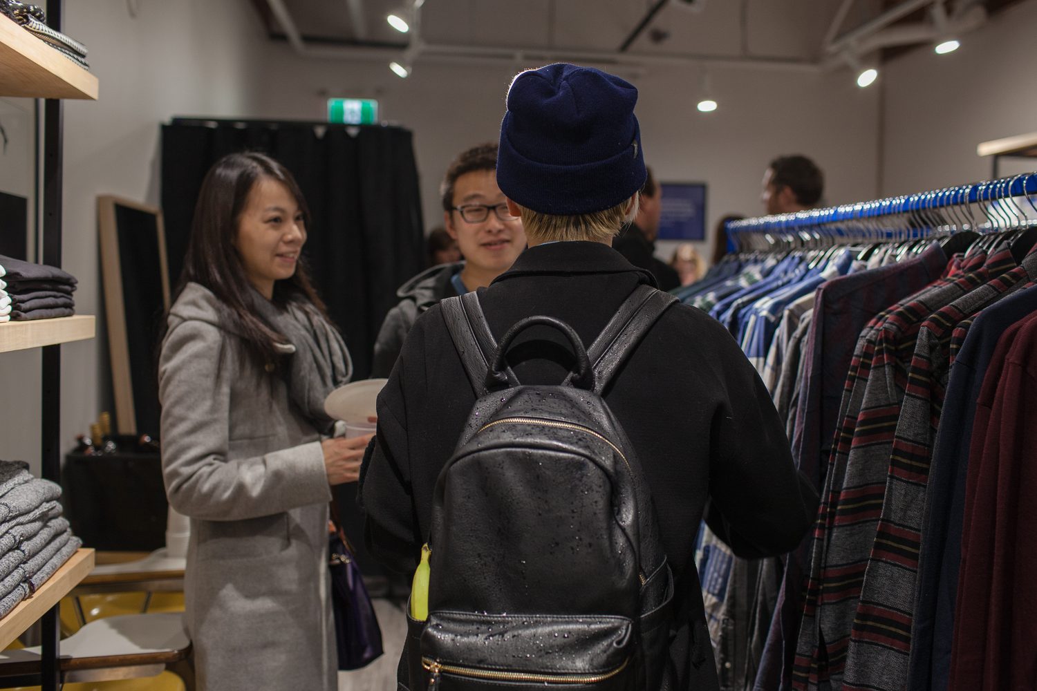 Frank & Oak Colour corporate story frame 10: Retail event photography for Frank & Oak Colour at The Blue Shop on Abbott Street in Vancouver, with the storefront, guests, clothing, details and the room in use.
