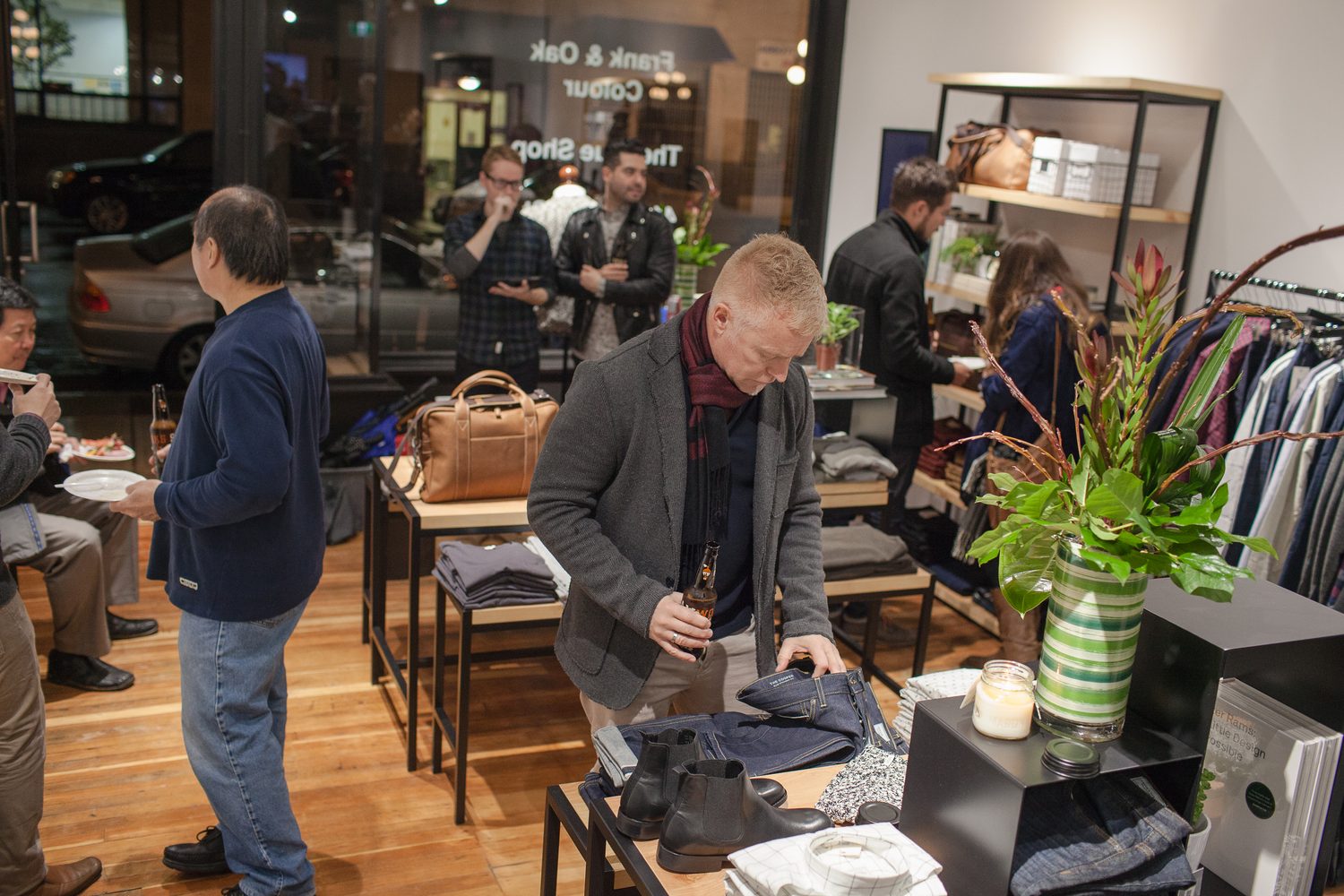 Frank & Oak Colour corporate story frame 16: Retail event photography for Frank & Oak Colour at The Blue Shop on Abbott Street in Vancouver, with the storefront, guests, clothing, details and the room in use.
