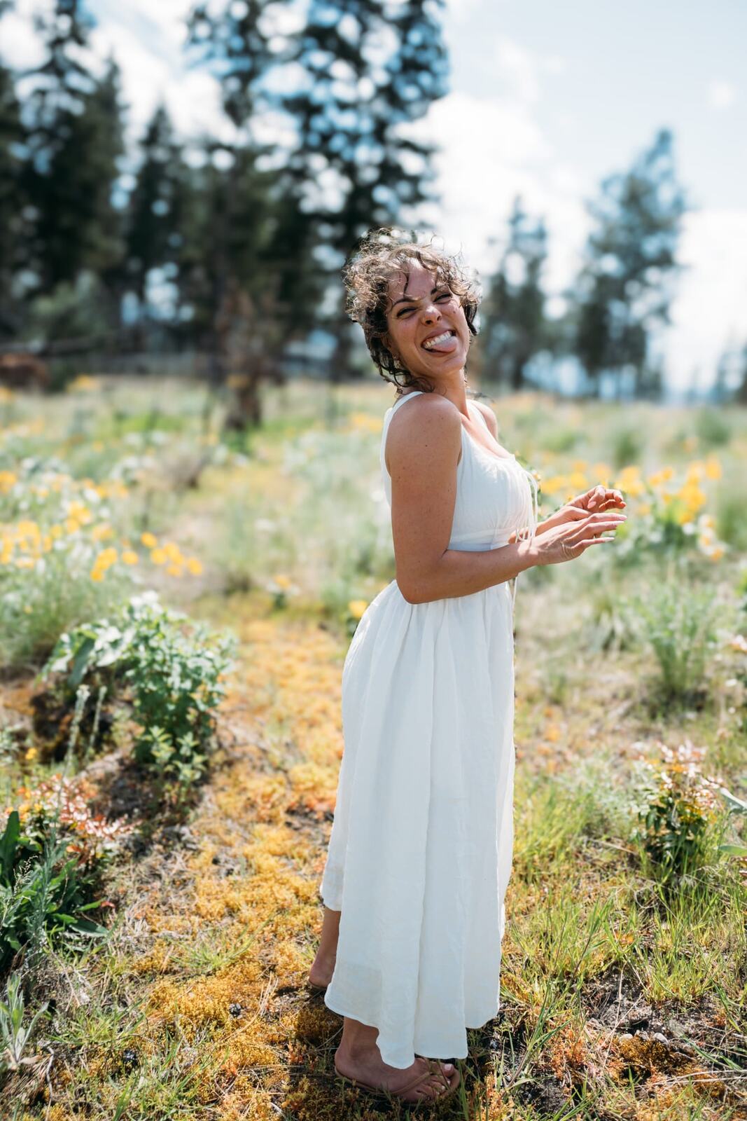 Giuliana at LoveReins portraits story frame 2: Equestrian portrait session at Love Reins Ranch in Lake Country, BC, with Giuliana, horses, white-dress portraits, Western cowgirl styling, ranch fencing, riding frames and warm Okanagan light..