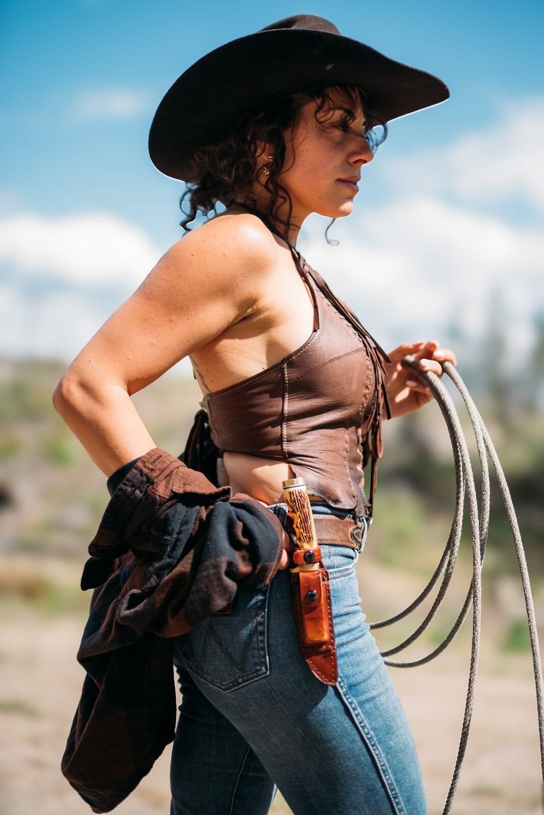 Giuliana at LoveReins portraits story frame 8: Equestrian portrait session at Love Reins Ranch in Lake Country, BC, with Giuliana, horses, white-dress portraits, Western cowgirl styling, ranch fencing, riding frames and warm Okanagan light..
