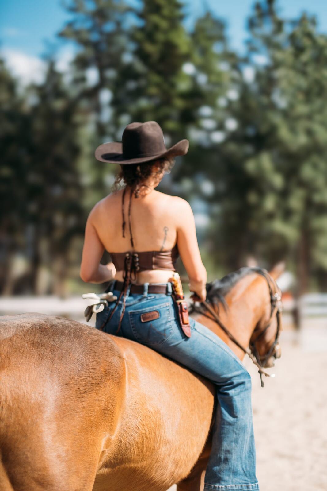 Giuliana at LoveReins portraits story frame 16: Equestrian portrait session at Love Reins Ranch in Lake Country, BC, with Giuliana, horses, white-dress portraits, Western cowgirl styling, ranch fencing, riding frames and warm Okanagan light..