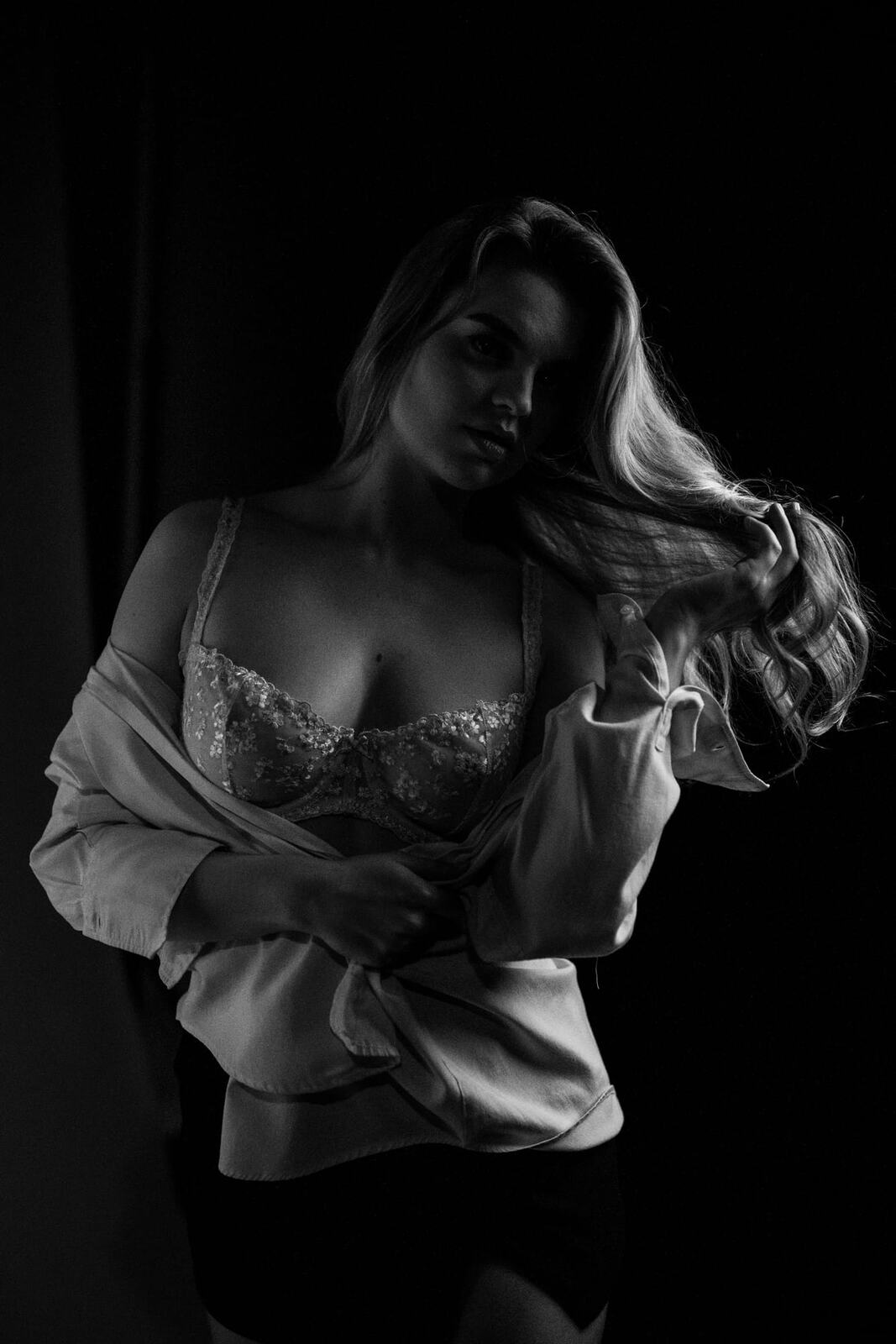 Hannah K in Black and White portraits story frame 7: A black-and-white studio portrait study with clean wardrobe shifts, close face work and controlled light.