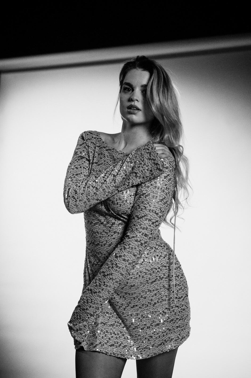 Hannah K in Black and White portraits story frame 35: A black-and-white studio portrait study with clean wardrobe shifts, close face work and controlled light.