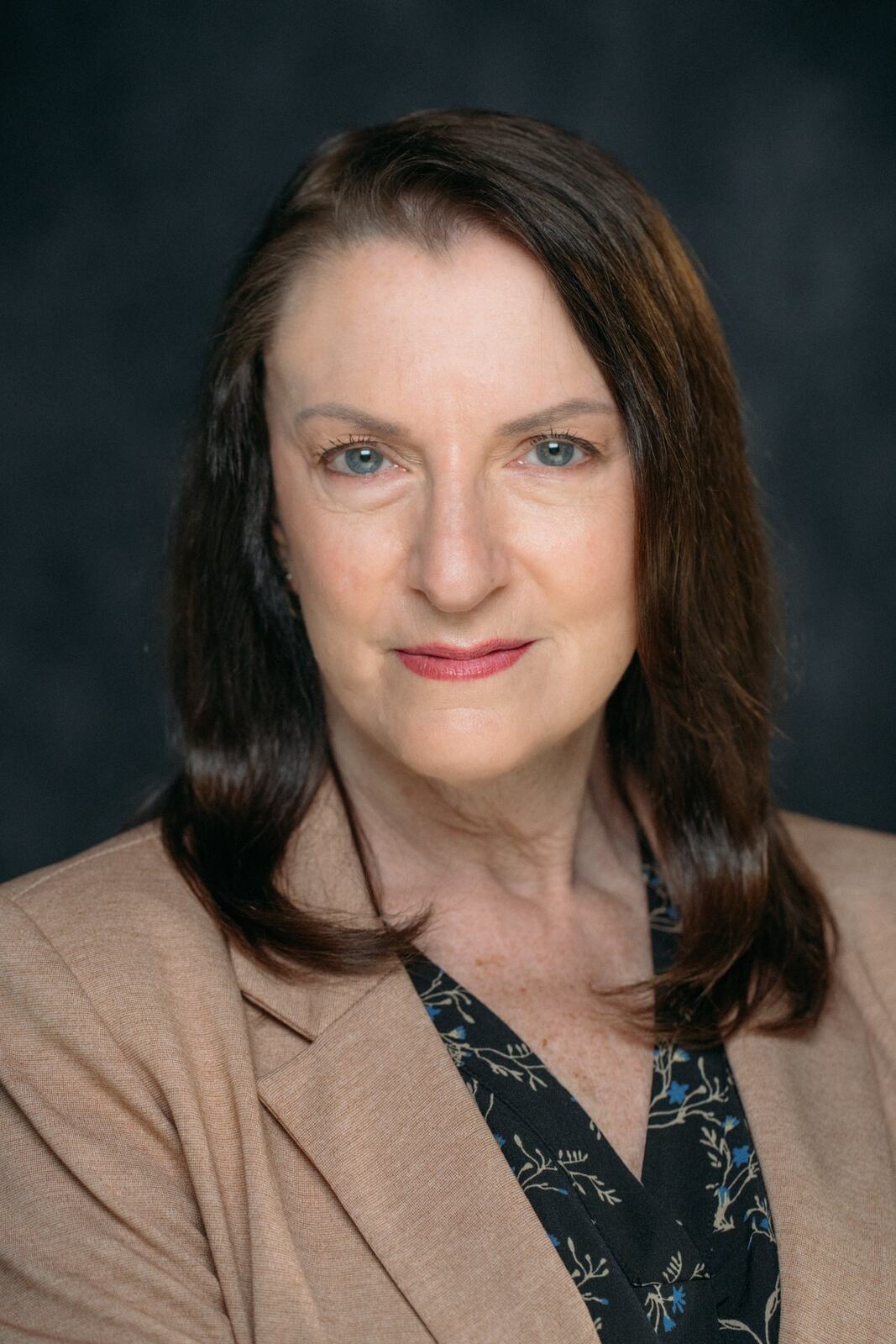 Marie in a tan blazer for a polished profile portrait