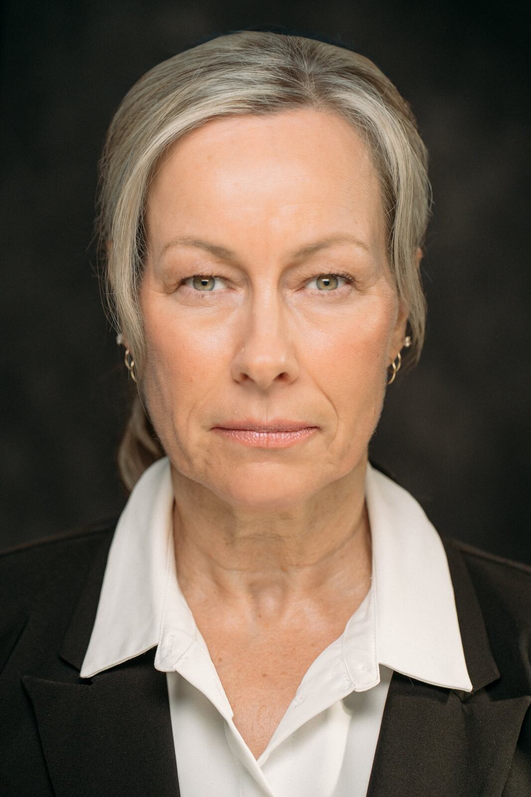 Shaye in a black blazer for a formal headshot