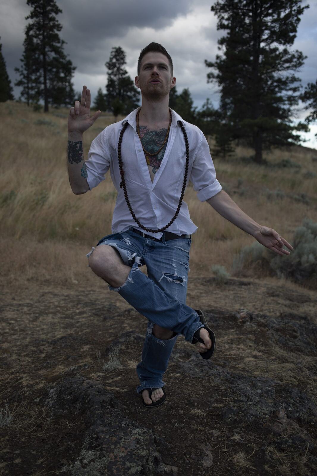 Jacob holding a tree pose on the hillside.