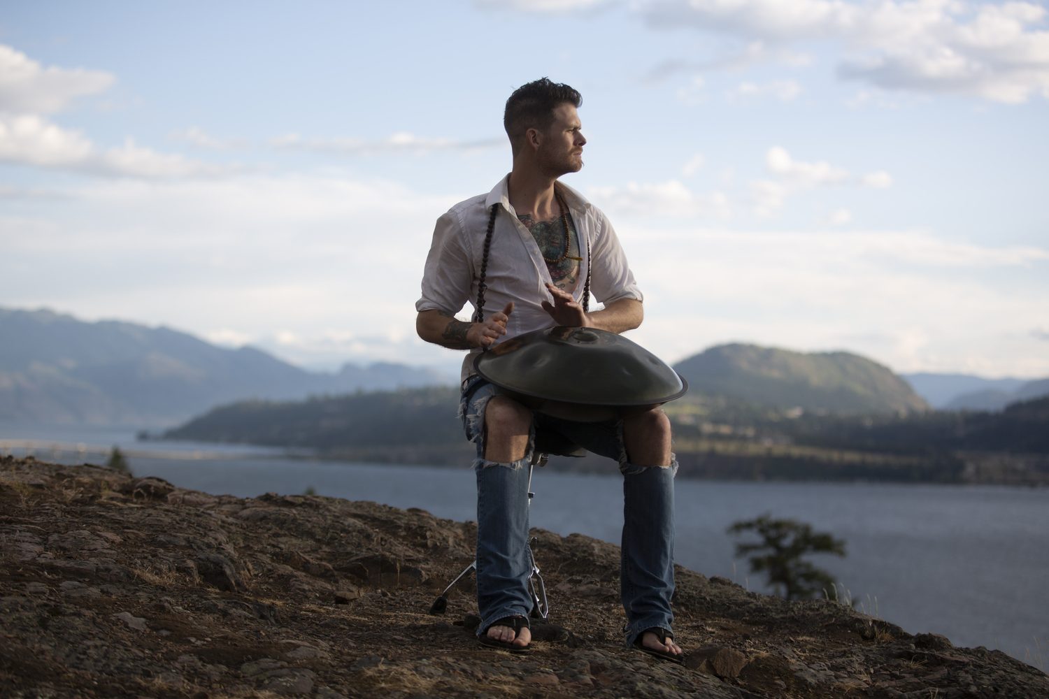 Jacob pausing at the handpan and looking across the hillside.