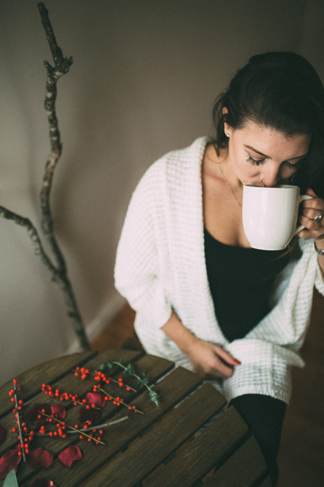 Jasmin by the Window portrait story frame 9: Window-light portraits with Jasmin beside a small table, tea and winter greenery in Kelowna, British Columbia.