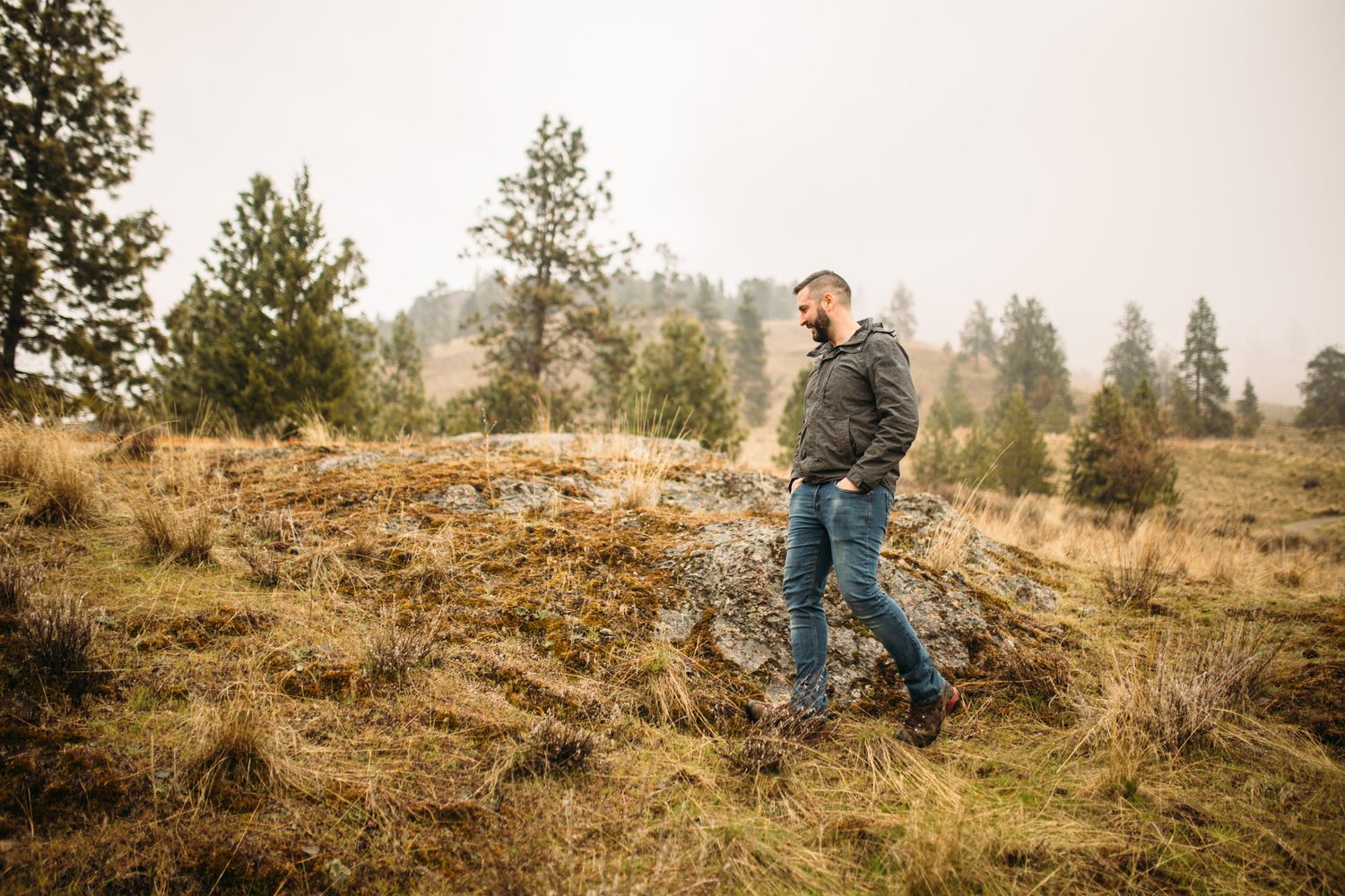 Jeremy standing in warm hillside light in a dark blazer for Optimize Organics.