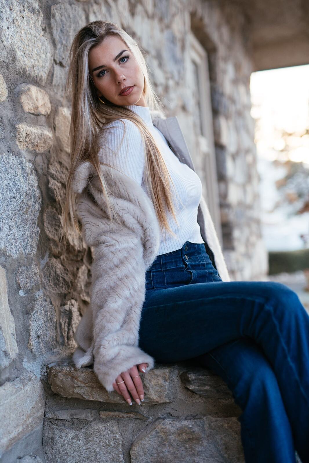 Kaylee at Lier House portraits story frame 12: Penticton portraits for Kaylee at Lier House, moving from window light and interior texture into stone steps, pale winter colour and quiet exterior portrait range.