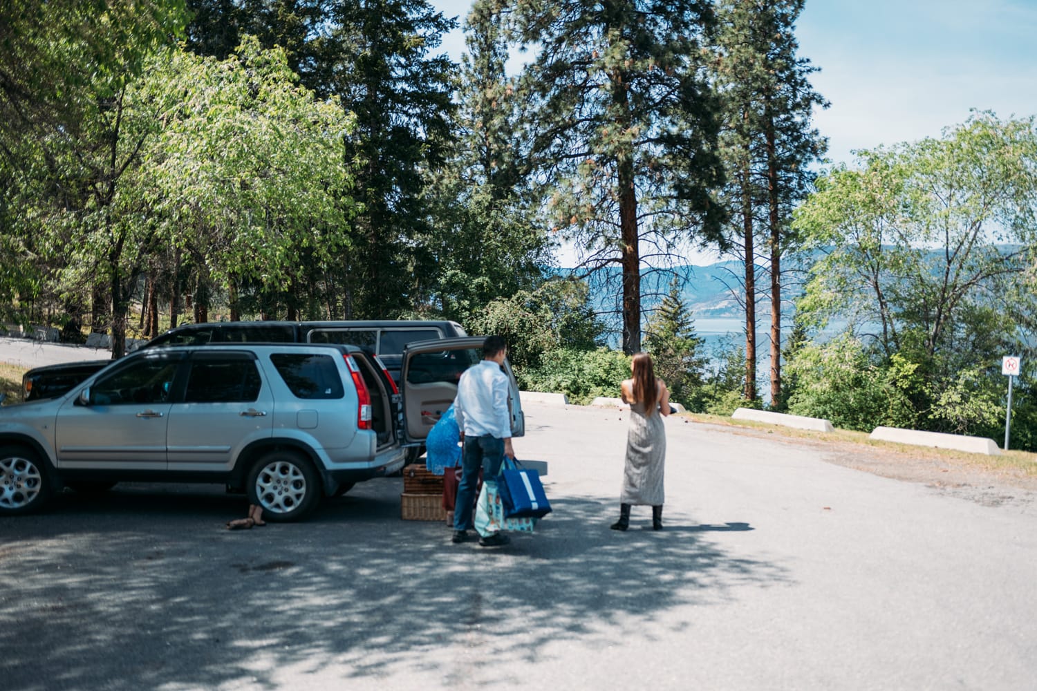 Kristina and Mark weddings story frame 1: A Bertram Creek wedding in South Kelowna with Okanagan Lake light, film-friend history, family texture and Lithuanian food and planning details..