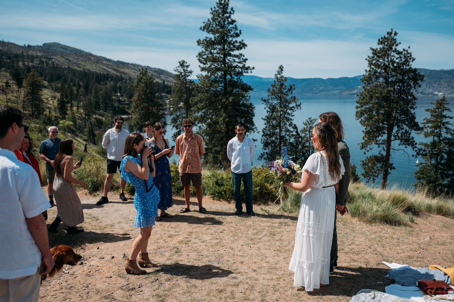 Kristina and Mark weddings story frame 5: A Bertram Creek wedding in South Kelowna with Okanagan Lake light, film-friend history, family texture and Lithuanian food and planning details..
