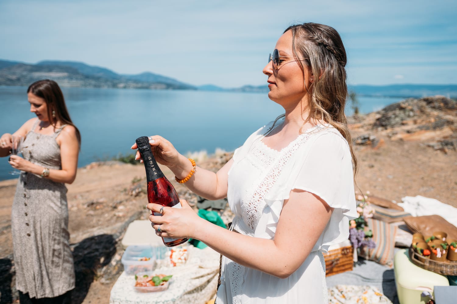 Kristina and Mark weddings story frame 17: A Bertram Creek wedding in South Kelowna with Okanagan Lake light, film-friend history, family texture and Lithuanian food and planning details..