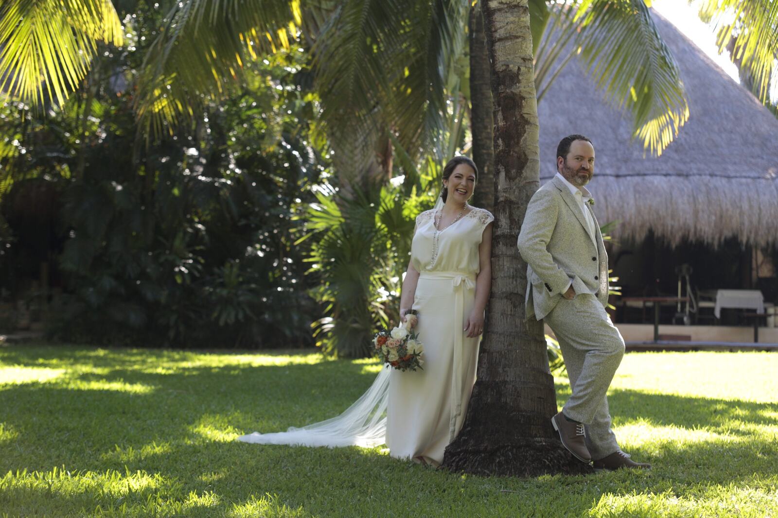 Kyra and Ted standing together beneath the palms