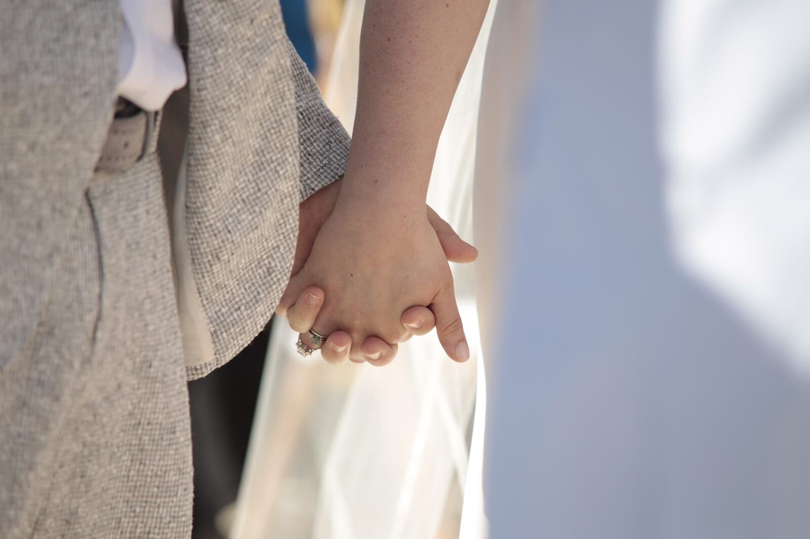 Kyra and Ted holding hands during the ceremony