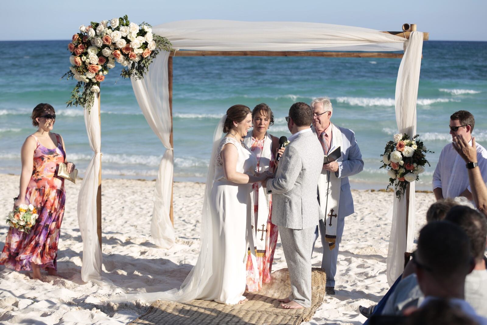 Kyra and Ted together beneath the floral ceremony arch
