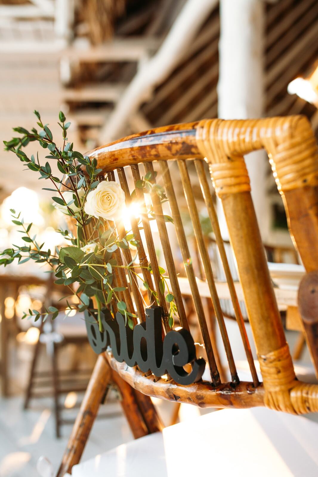Kyra and Ted's reception chairs decorated with greenery