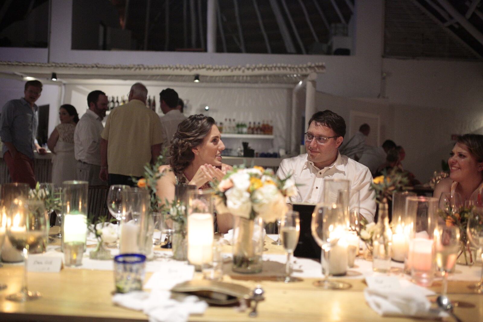 Kyra and Ted with family and friends at the reception table