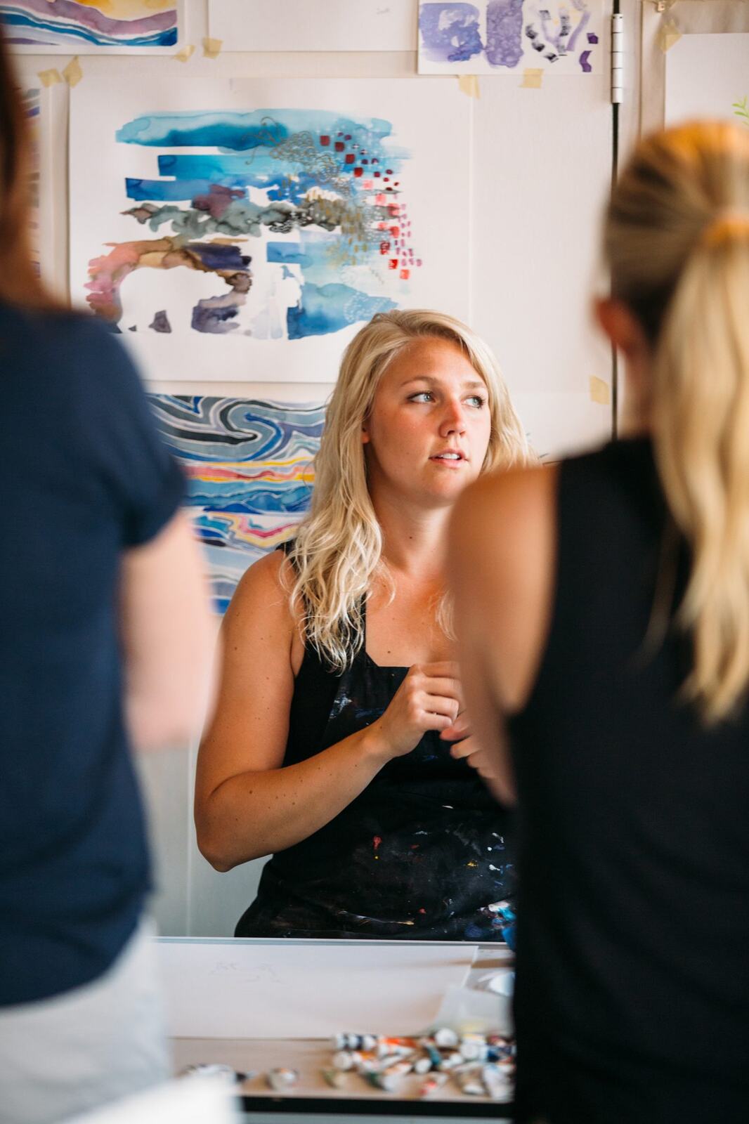 Participant rinsing a brush during the workshop.