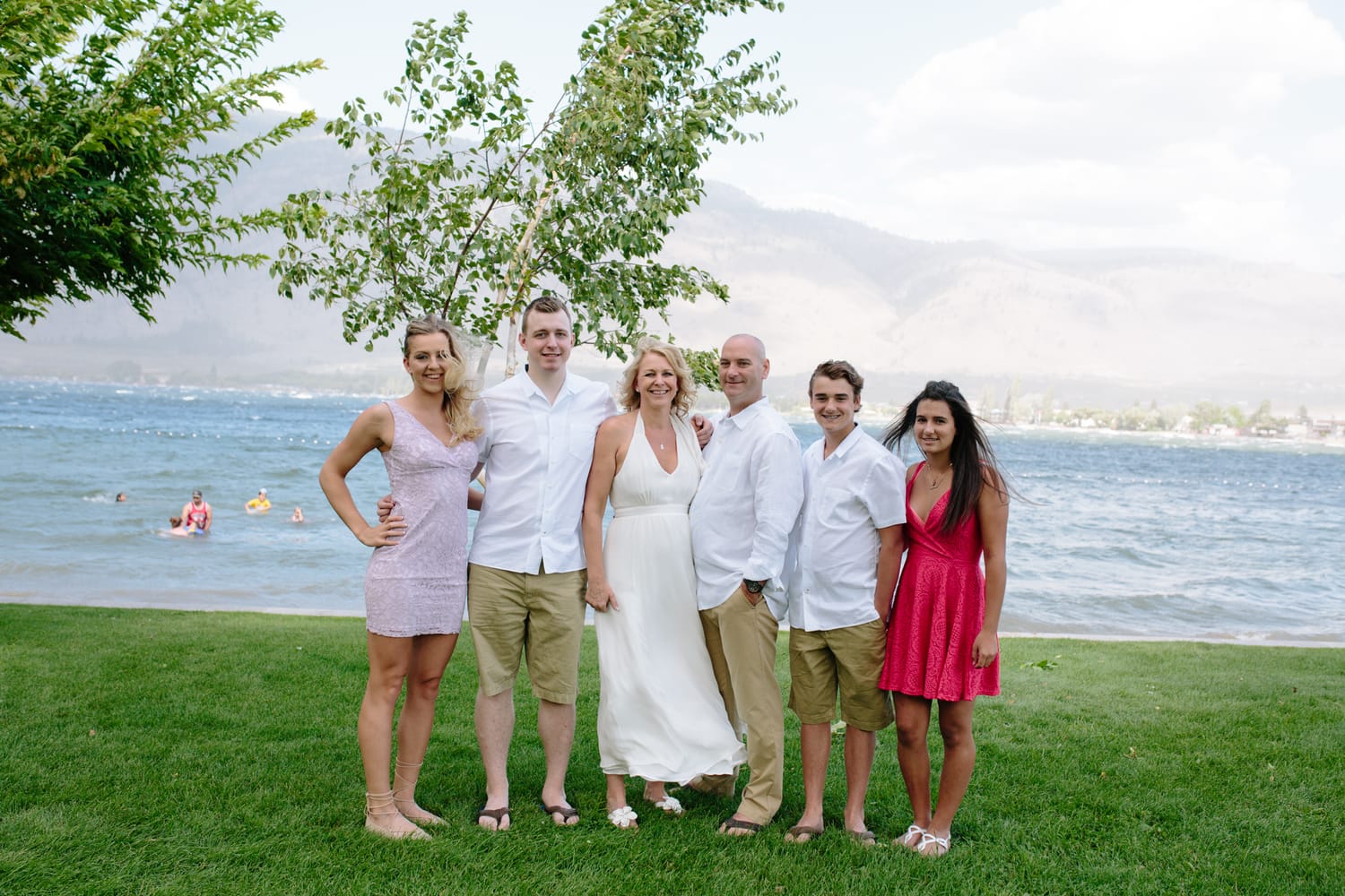 Leeanne and Kelly weddings story frame 1: A Watermark Beach Resort wedding in Osoyoos, built around lakefront context, grown-family connection and careful, big-hearted coverage..