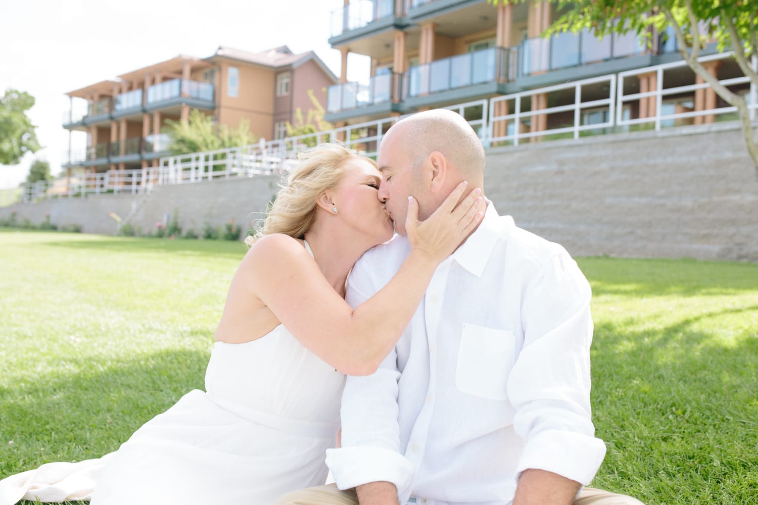 Leeanne and Kelly weddings story frame 5: A Watermark Beach Resort wedding in Osoyoos, built around lakefront context, grown-family connection and careful, big-hearted coverage..