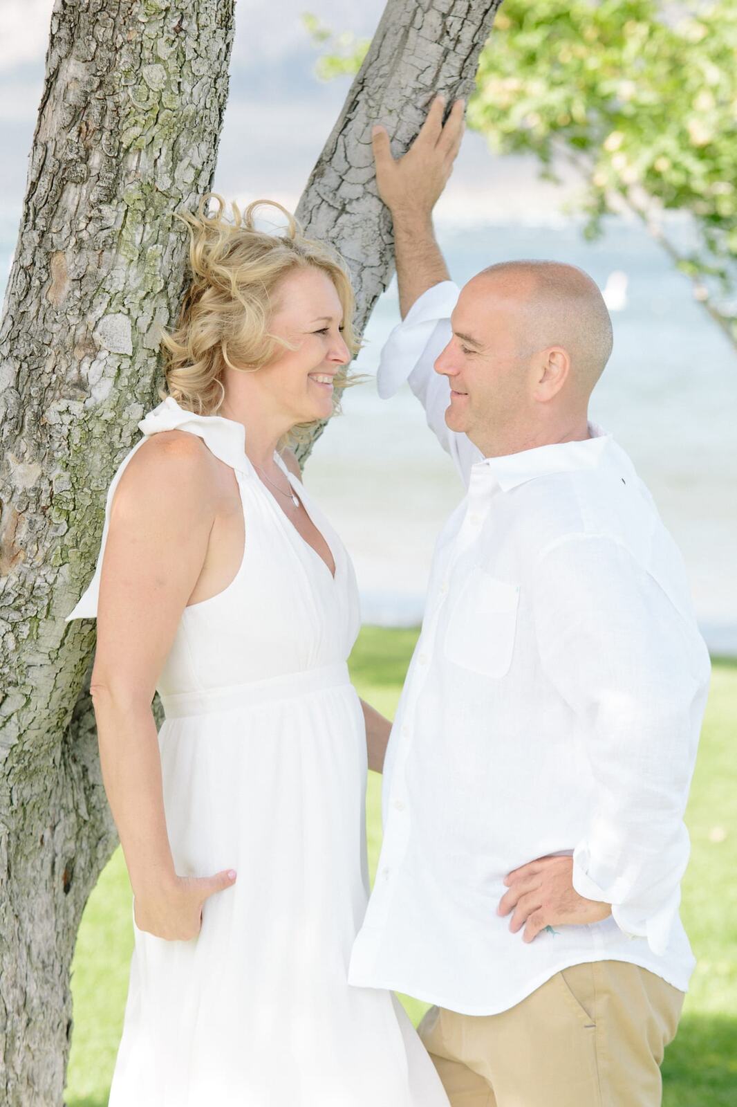 Leeanne and Kelly weddings story frame 7: A Watermark Beach Resort wedding in Osoyoos, built around lakefront context, grown-family connection and careful, big-hearted coverage..
