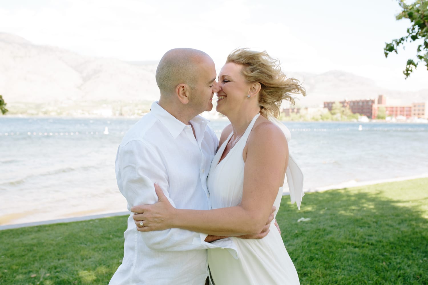 Leeanne and Kelly weddings story frame 9: A Watermark Beach Resort wedding in Osoyoos, built around lakefront context, grown-family connection and careful, big-hearted coverage..