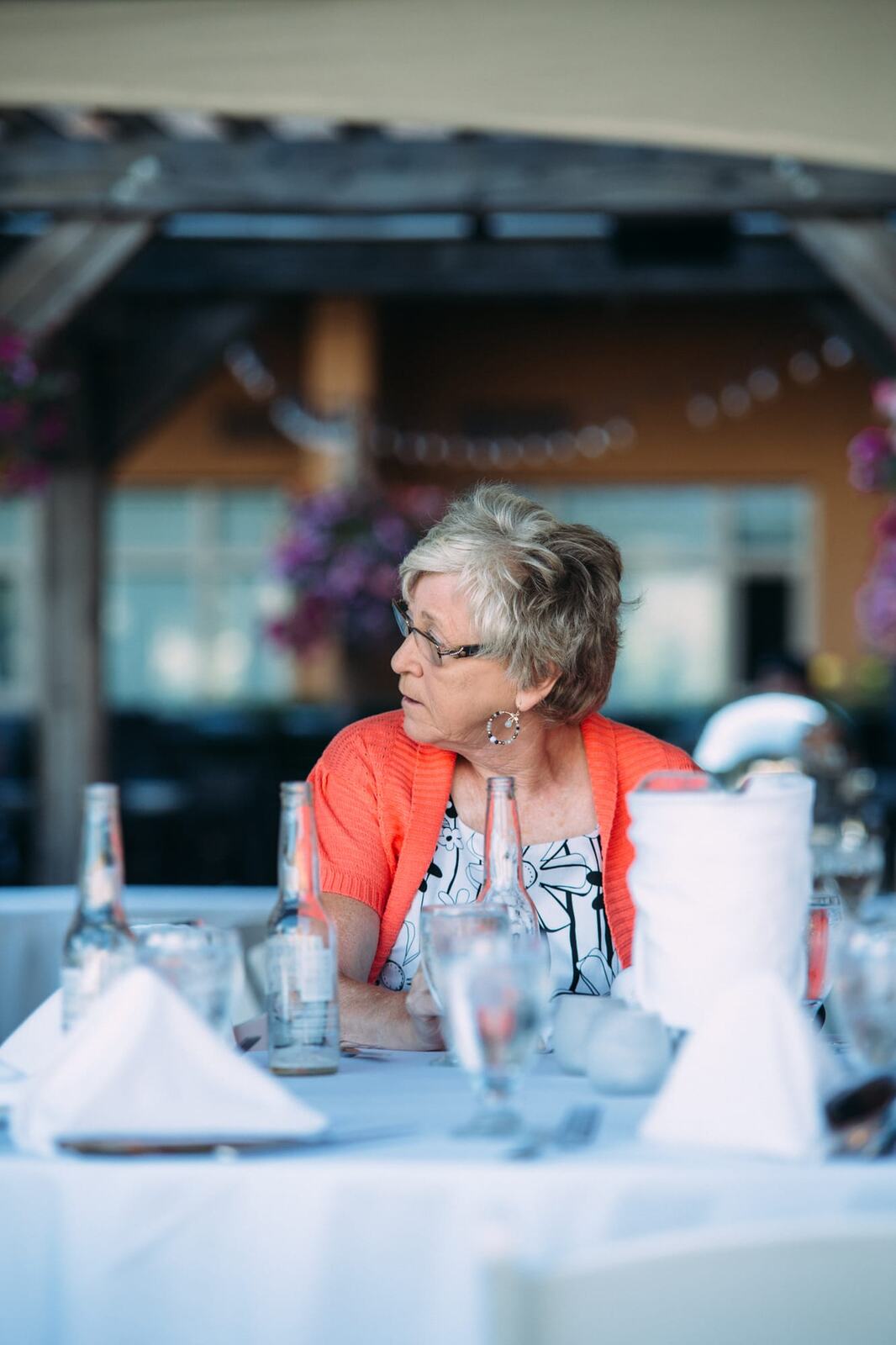 Leeanne and Kelly weddings story frame 12: A Watermark Beach Resort wedding in Osoyoos, built around lakefront context, grown-family connection and careful, big-hearted coverage..
