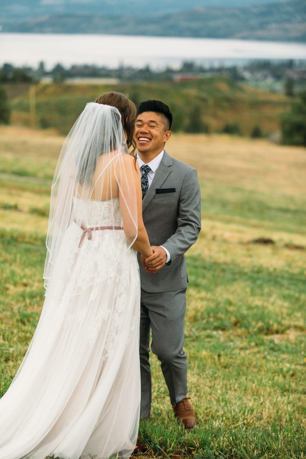 Leslie and Gerome weddings story frame 1: A Brook & Barn - Casorso Heritage Farm wedding in Kelowna, with orchard details, outbuildings, lawn games and a familiar friend-party feeling..