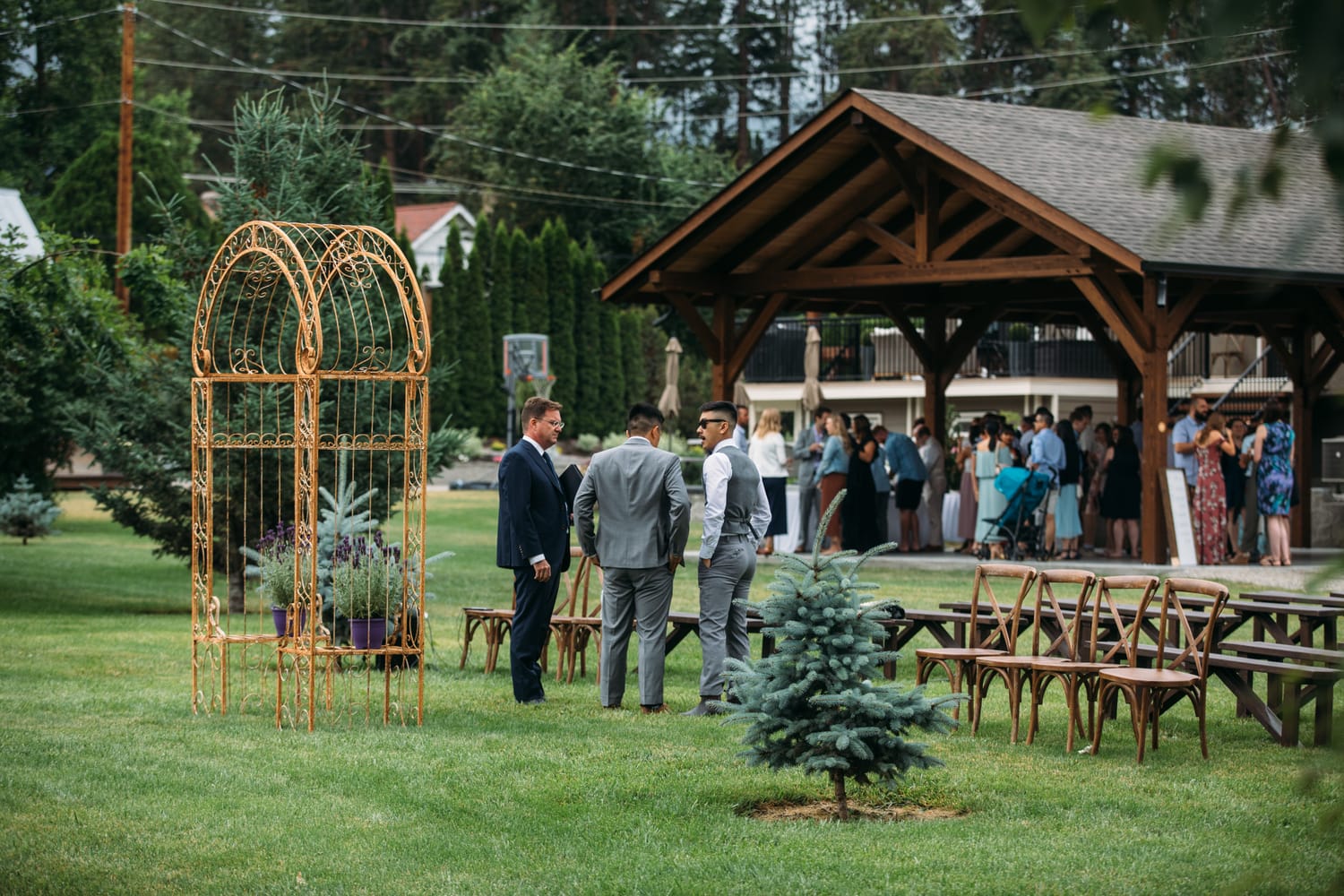 Leslie and Gerome weddings story frame 7: A Brook & Barn - Casorso Heritage Farm wedding in Kelowna, with orchard details, outbuildings, lawn games and a familiar friend-party feeling..