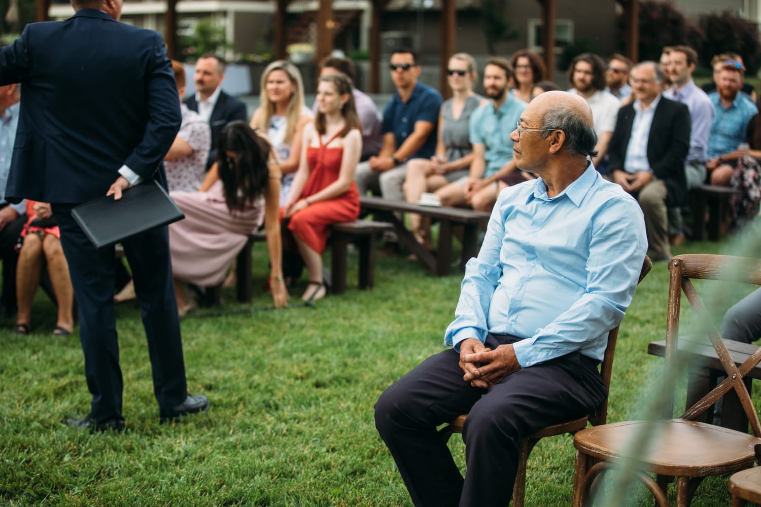 Leslie and Gerome weddings story frame 10: A Brook & Barn - Casorso Heritage Farm wedding in Kelowna, with orchard details, outbuildings, lawn games and a familiar friend-party feeling..