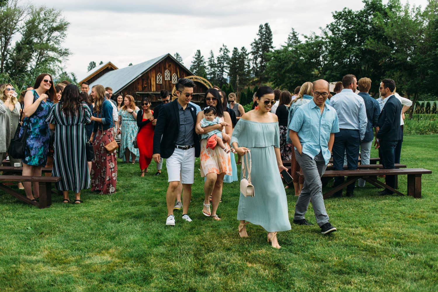 Leslie and Gerome weddings story frame 17: A Brook & Barn - Casorso Heritage Farm wedding in Kelowna, with orchard details, outbuildings, lawn games and a familiar friend-party feeling..