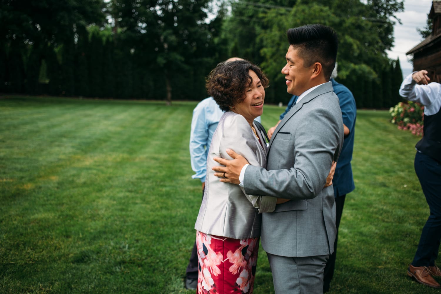 Leslie and Gerome weddings story frame 18: A Brook & Barn - Casorso Heritage Farm wedding in Kelowna, with orchard details, outbuildings, lawn games and a familiar friend-party feeling..