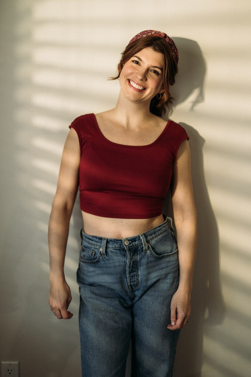 Marie at Clement portraits story frame 5: Actor and performer portraits on Clement Avenue in Kelowna, with red, black and leather wardrobe changes, slatted light and portfolio range for casting, promo and look-book use.