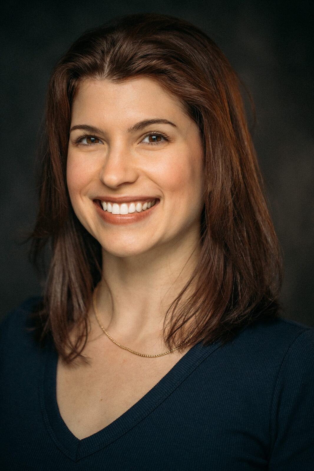 Marie smiling in a blue shirt headshot