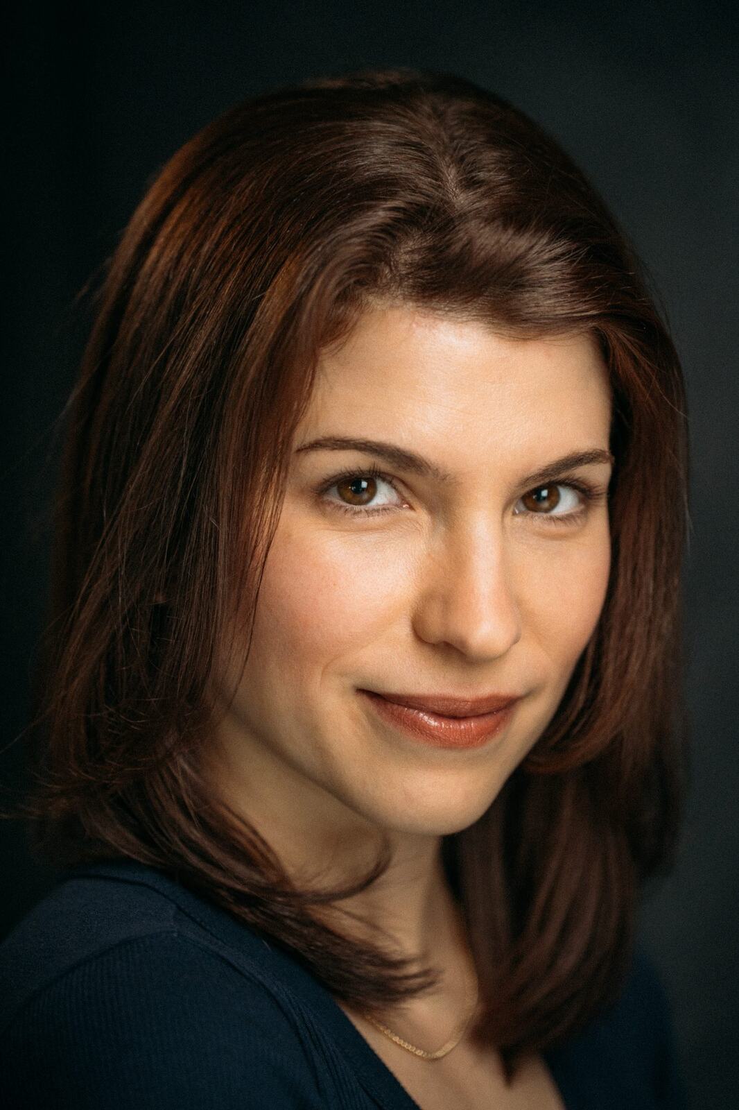 Marie laughing in a close blue shirt portrait