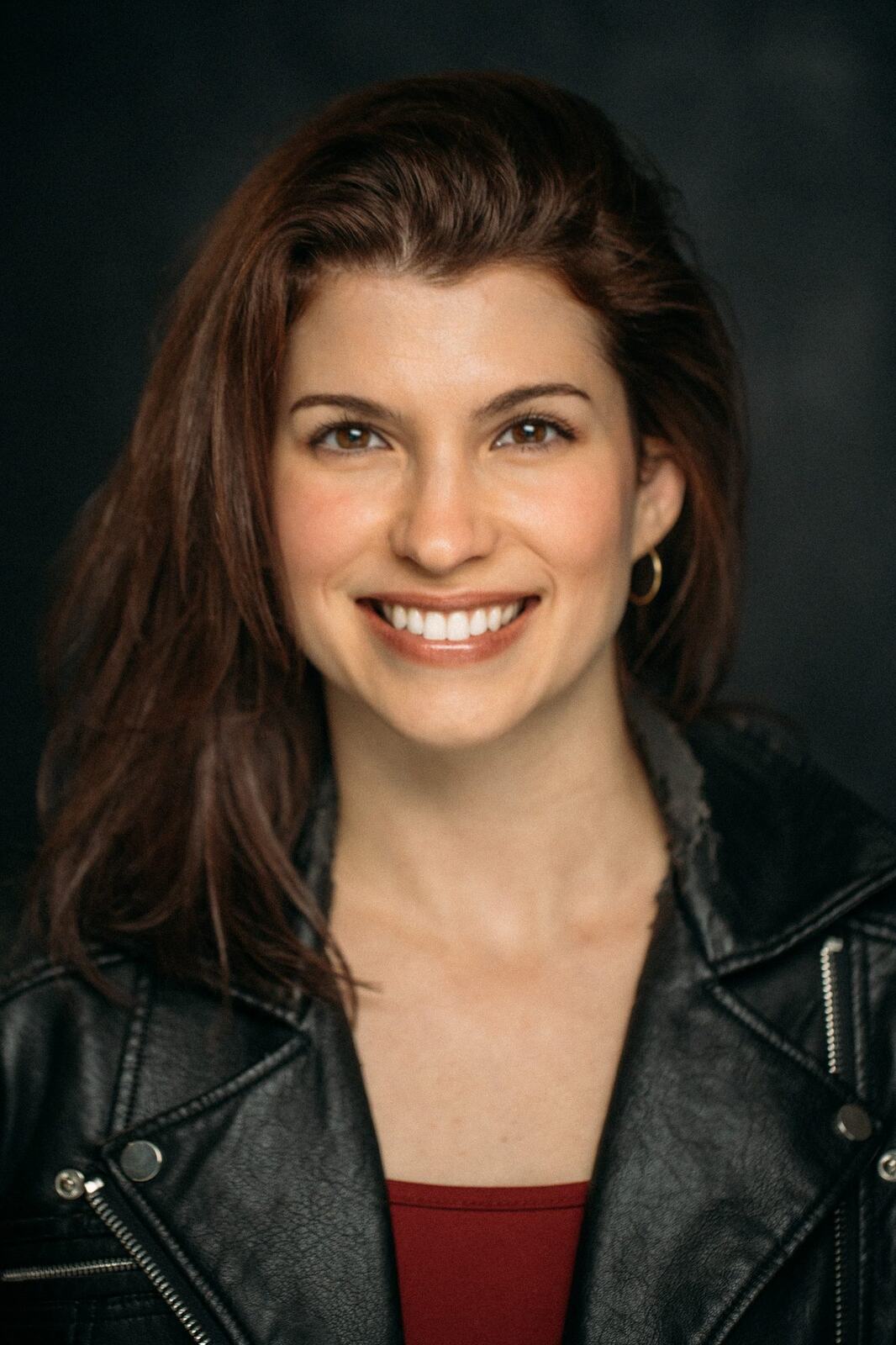 Marie in a leather jacket with her hair swept back