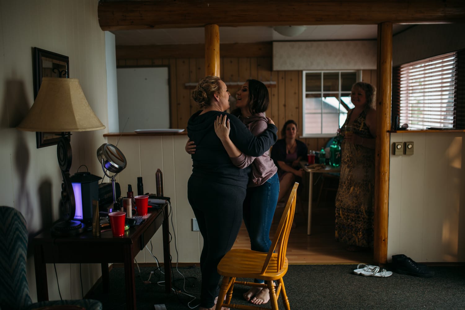 Marie and Mark weddings story frame 7: A Mabel Lake Airpark wedding in the North Okanagan, with grass-runway scenery, open-air photos and sweet family help around makeup, flowers and petals..