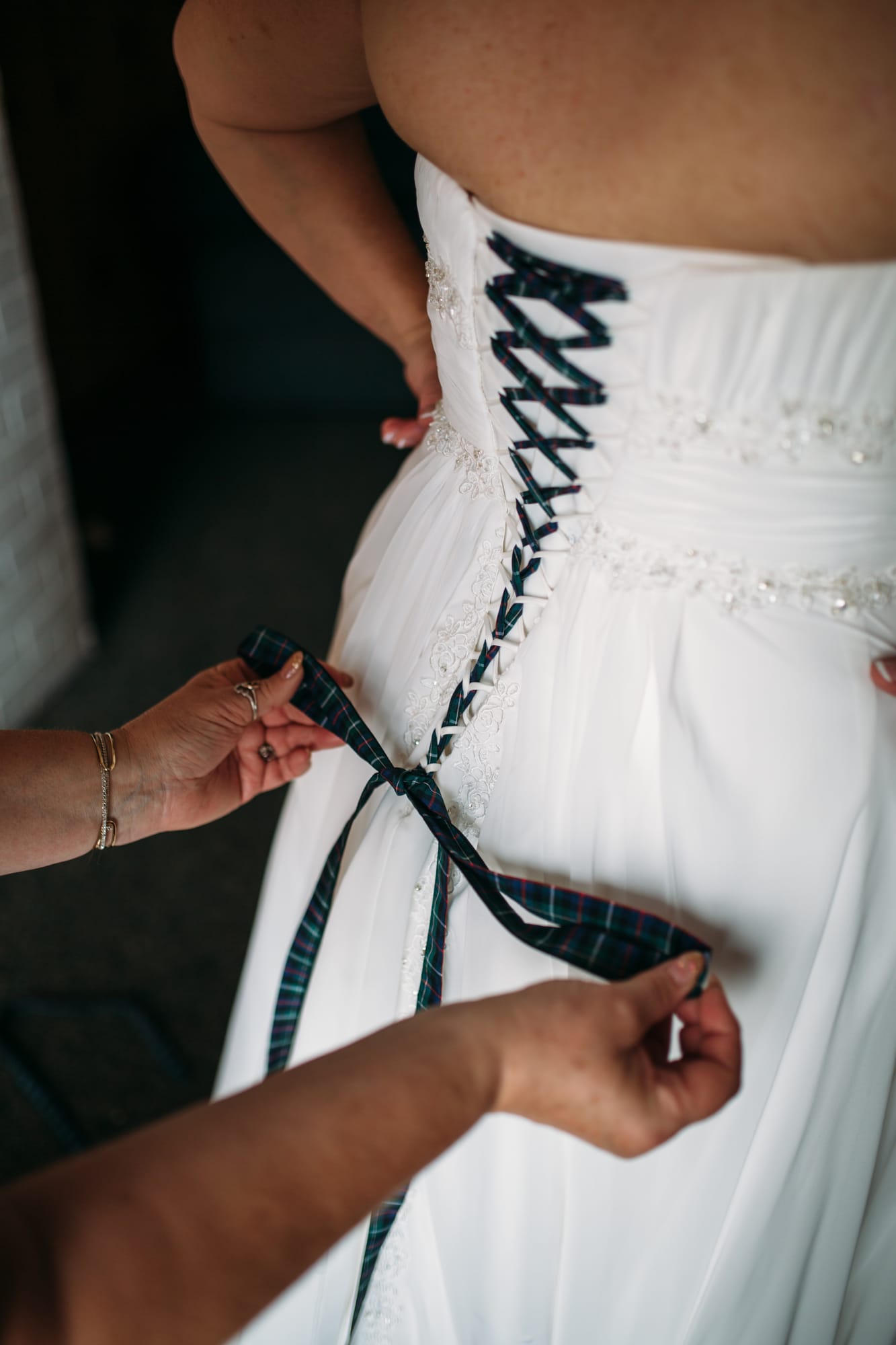 Marie and Mark weddings story frame 8: A Mabel Lake Airpark wedding in the North Okanagan, with grass-runway scenery, open-air photos and sweet family help around makeup, flowers and petals..