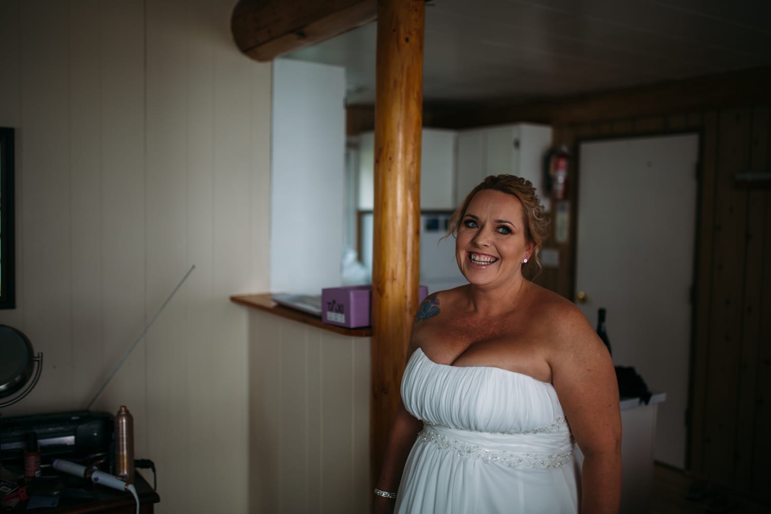 Marie and Mark weddings story frame 9: A Mabel Lake Airpark wedding in the North Okanagan, with grass-runway scenery, open-air photos and sweet family help around makeup, flowers and petals..