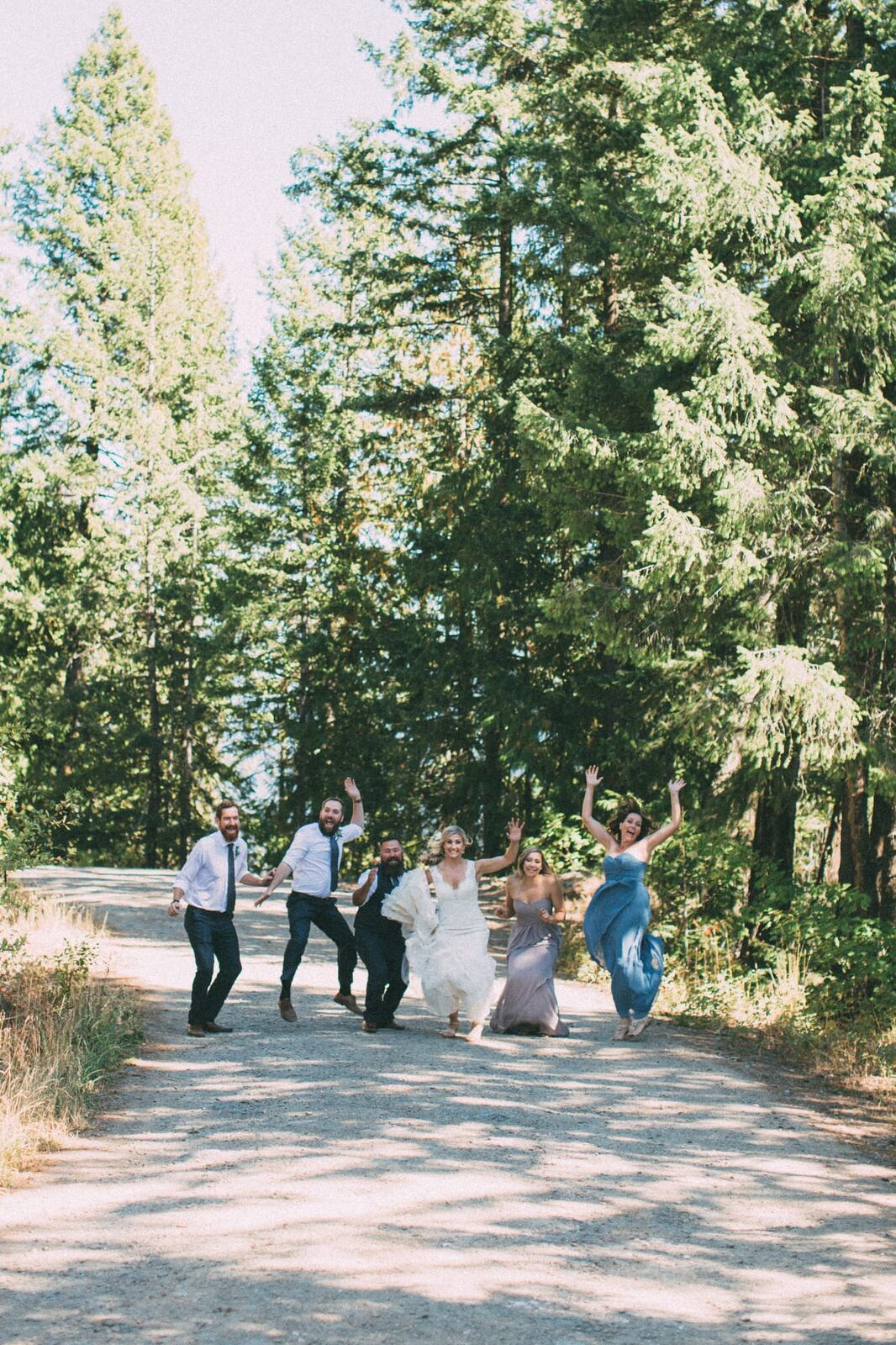 Megan and Jarid weddings story frame 13: A Shuswap-area wedding around Sicamous, Swansea Point and Hyde Mountain, with boat/lake context, cliff portraits and strong floral colour..