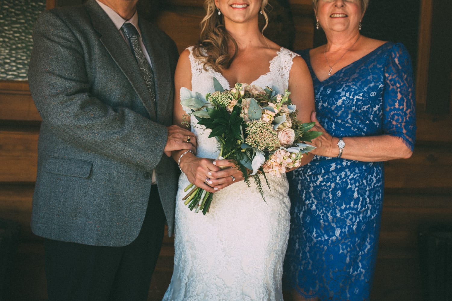 Megan and Jarid weddings story frame 15: A Shuswap-area wedding around Sicamous, Swansea Point and Hyde Mountain, with boat/lake context, cliff portraits and strong floral colour..