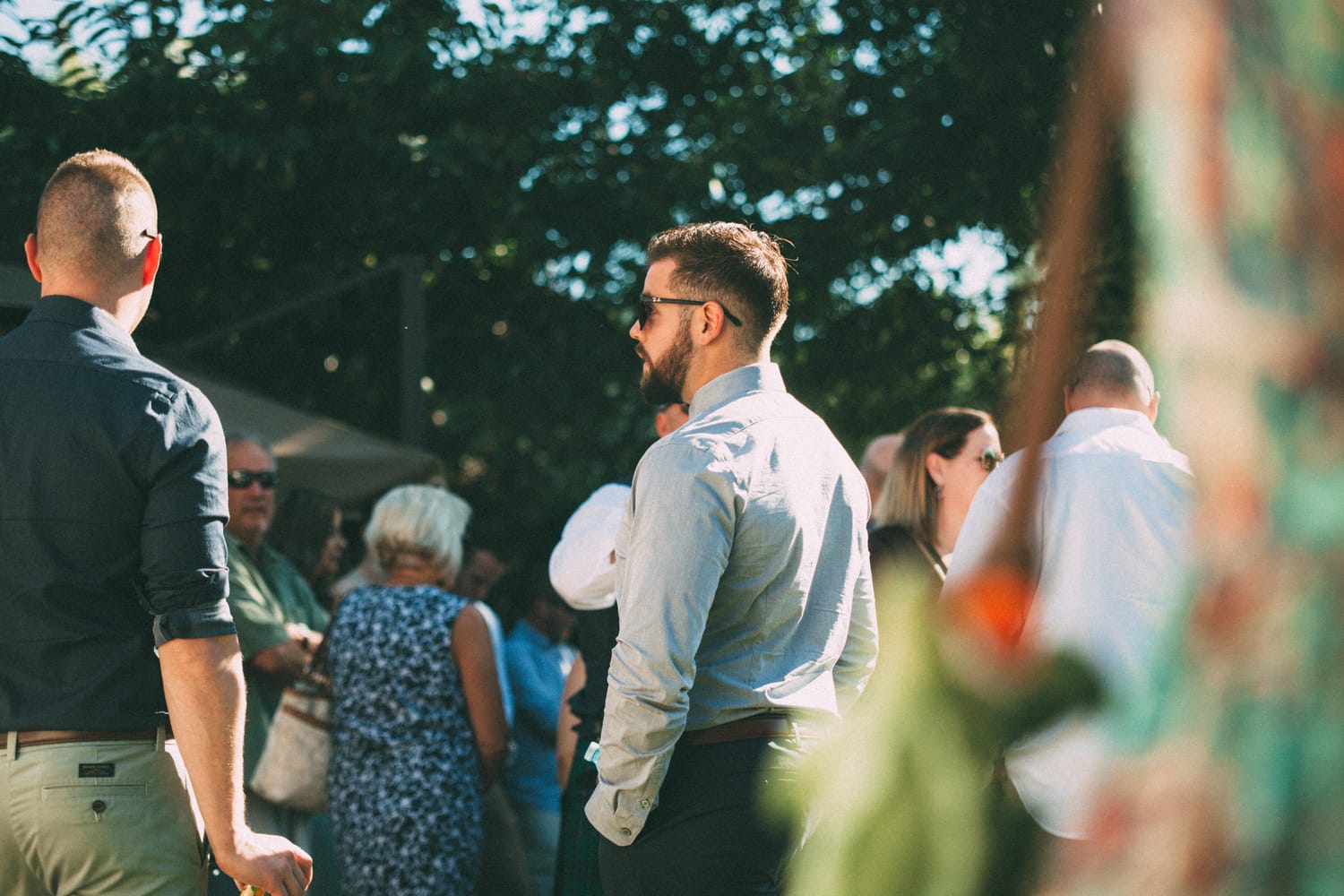 Megan and Jarid weddings story frame 16: A Shuswap-area wedding around Sicamous, Swansea Point and Hyde Mountain, with boat/lake context, cliff portraits and strong floral colour..