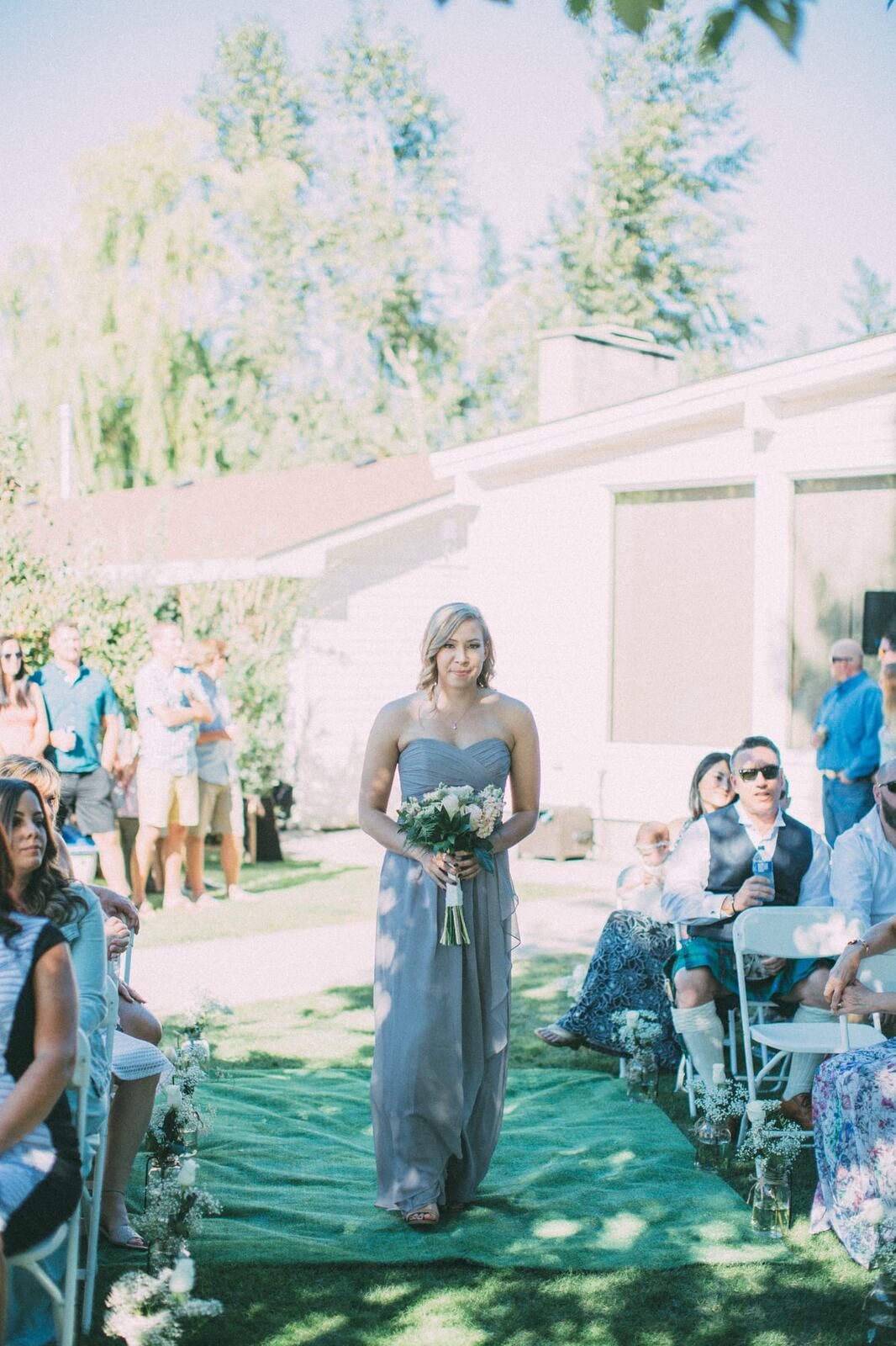 Megan and Jarid weddings story frame 18: A Shuswap-area wedding around Sicamous, Swansea Point and Hyde Mountain, with boat/lake context, cliff portraits and strong floral colour..