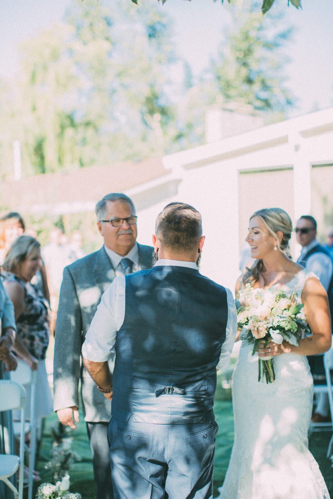 Megan and Jarid weddings story frame 19: A Shuswap-area wedding around Sicamous, Swansea Point and Hyde Mountain, with boat/lake context, cliff portraits and strong floral colour..