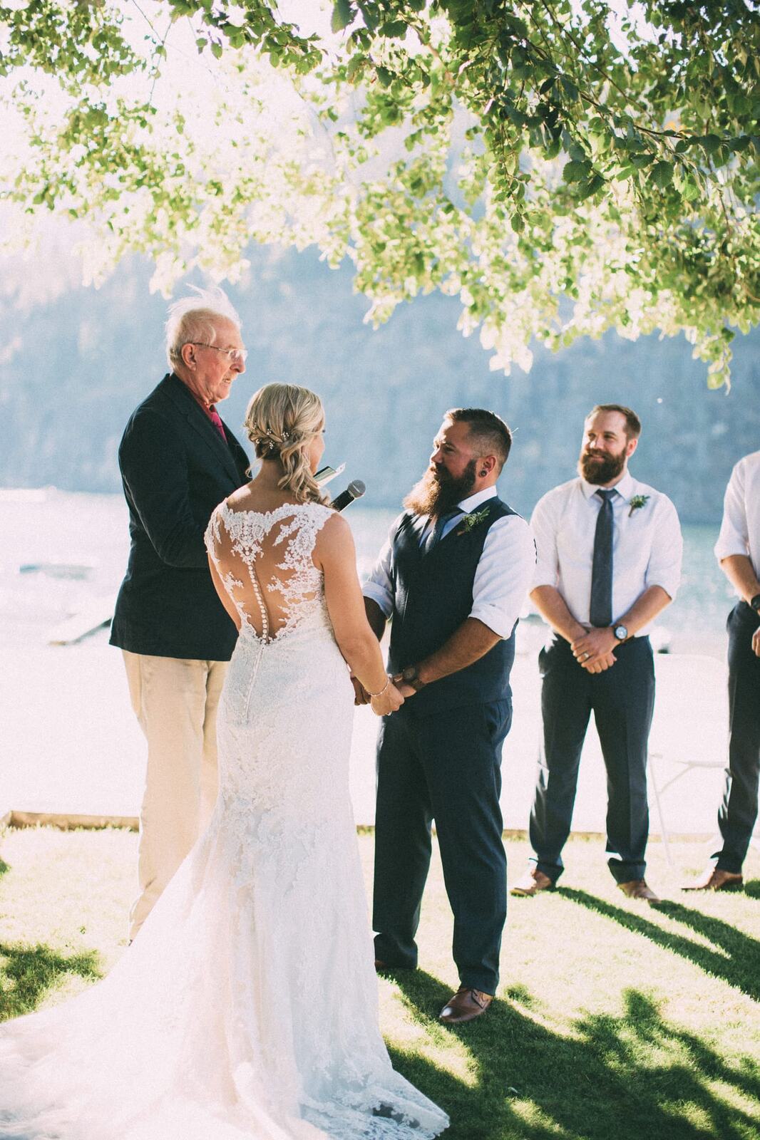 Megan and Jarid weddings story frame 20: A Shuswap-area wedding around Sicamous, Swansea Point and Hyde Mountain, with boat/lake context, cliff portraits and strong floral colour..