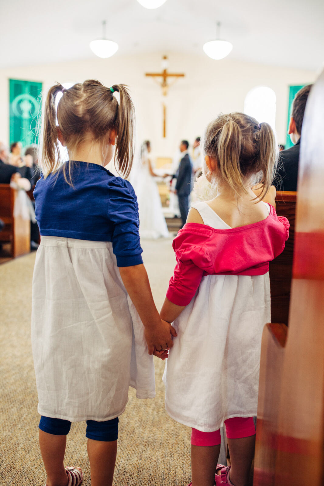 Two flower girls watching the ceremony